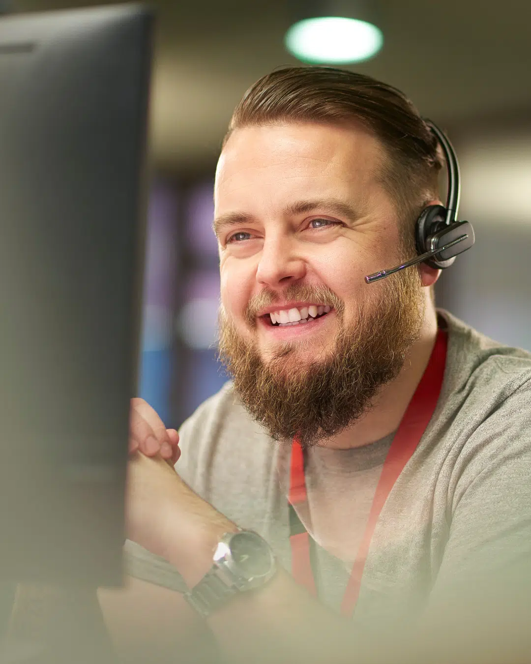 PCe Solutions Calgary IT support technician smiling while assisting a client