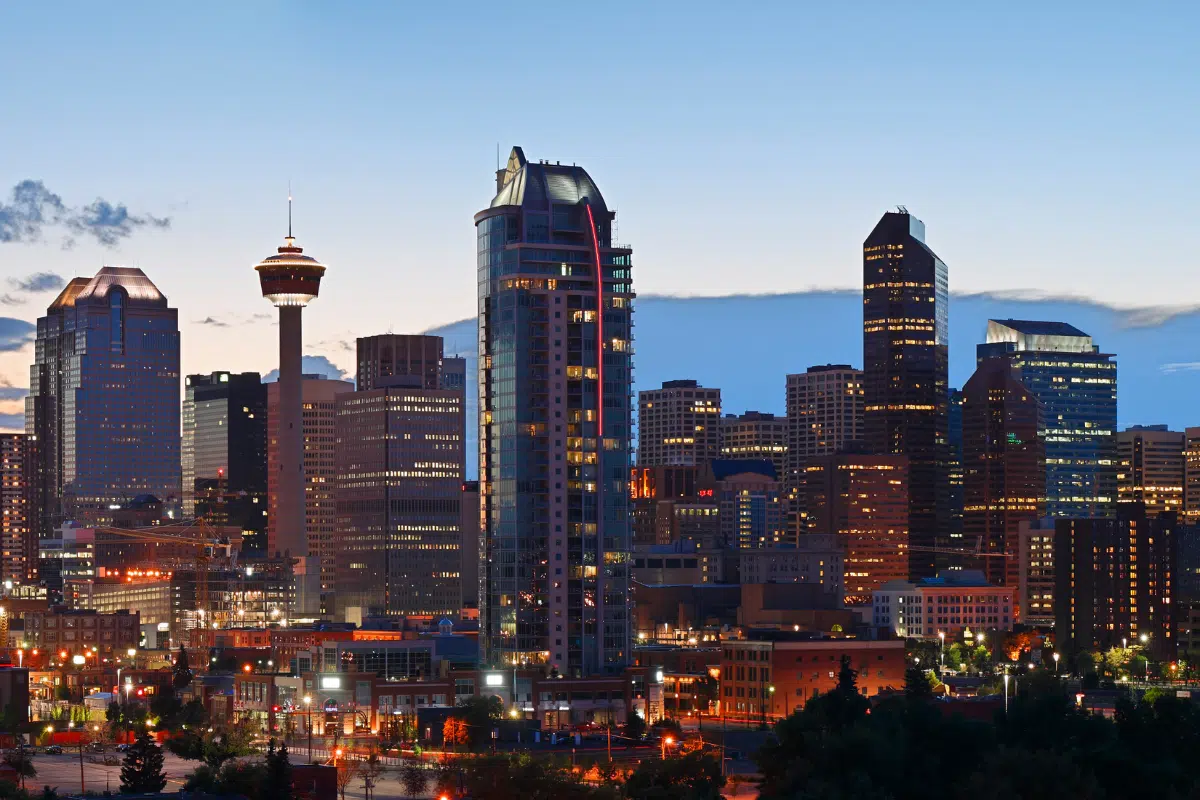 Calgary Alberta downtown skyline at night with the Calgary Tower illuminated representing the thriving small business community protected by PCe Solutions cybersecurity defense strategy and managed IT services across Alberta
