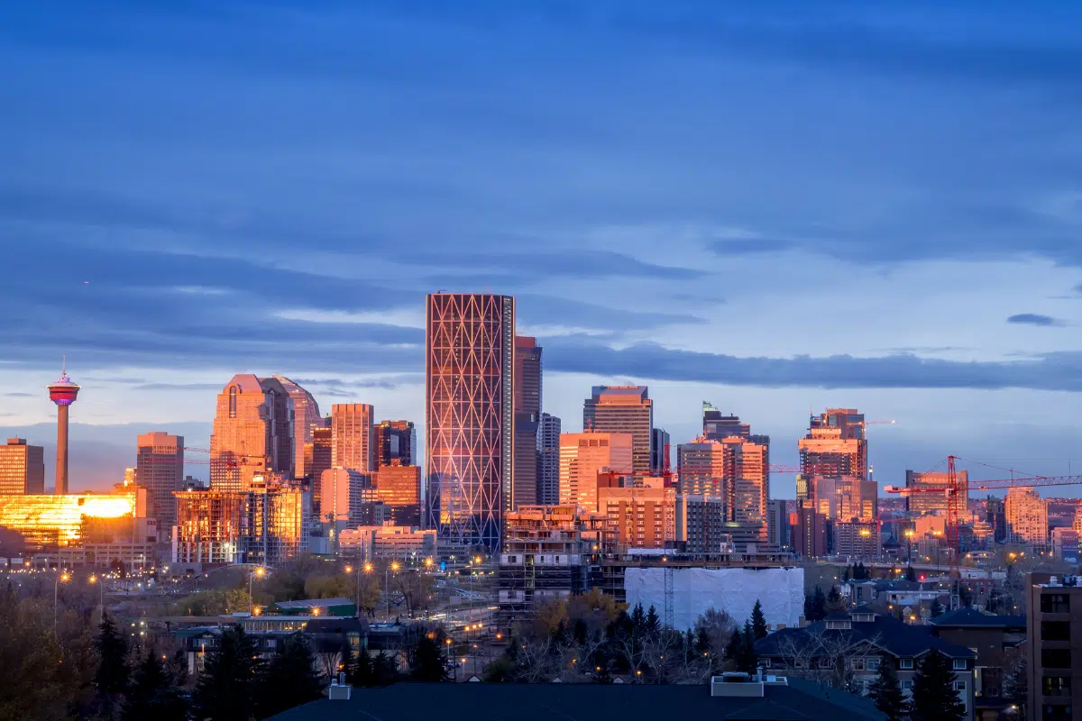 Calgary Alberta downtown skyline at dusk with the Calgary Tower illuminated against a deep blue sky, representing the thriving business community served by PCe Solutions cybersecurity and managed IT growth support