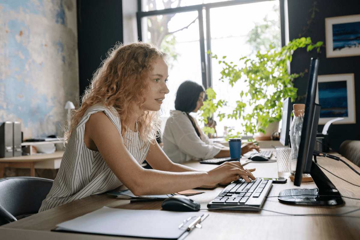 IT security professional monitoring financial systems and threat detection dashboards providing 24/7 cybersecurity protection for Calgary financial services firms through PCe Solutions managed IT services across Alberta
