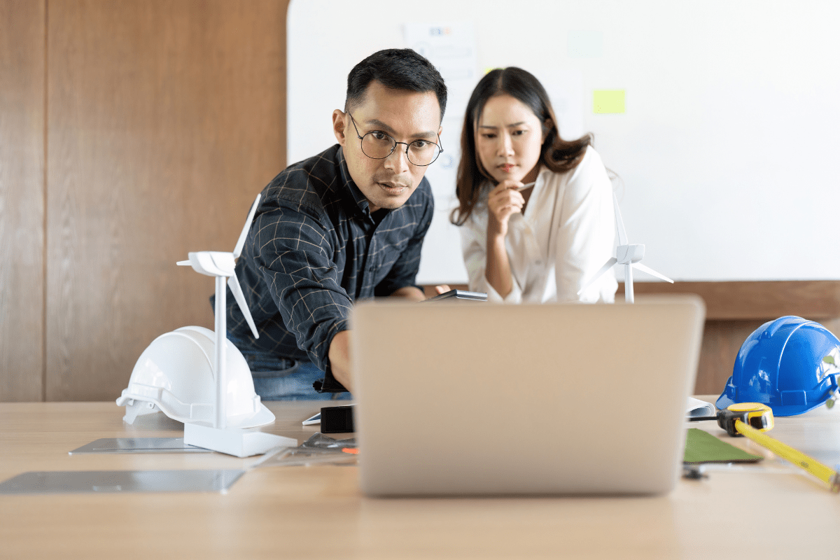 Tampa aerospace engineer reviewing technical schematics or CAD designs with AI-assisted tools near MacDill Air Force Base representing PCe Solutions Managed Intelligence AI services for Tampa defense contractors