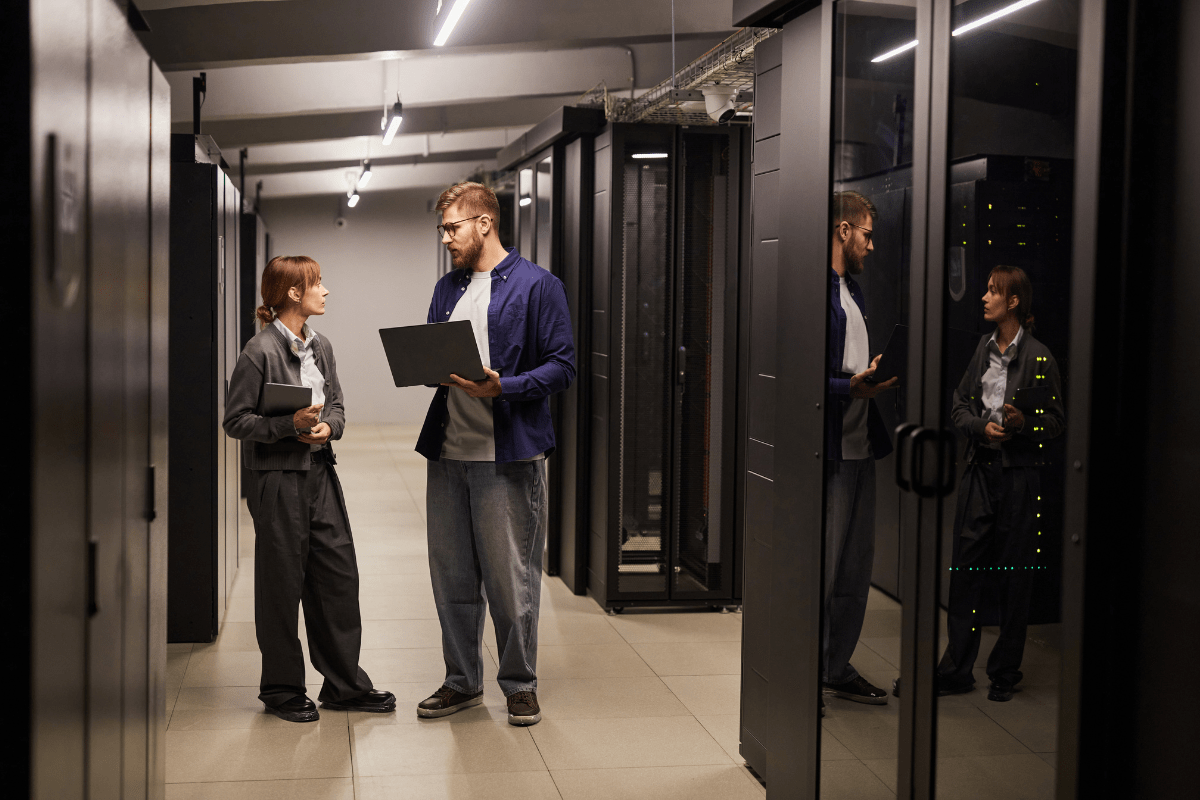 Calgary IT technician working hands-on at a business location troubleshooting network infrastructure or server equipment in a professional Calgary office environment representing PCe Solutions local on-site IT support services for organizations across Calgary and Southern Alberta