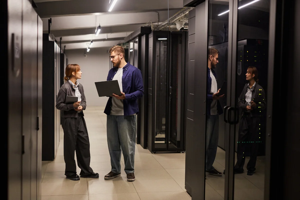 Calgary IT technician working hands-on at a business location troubleshooting network infrastructure or server equipment in a professional Calgary office environment representing PCe Solutions local on-site IT support services for organizations across Calgary and Southern Alberta
