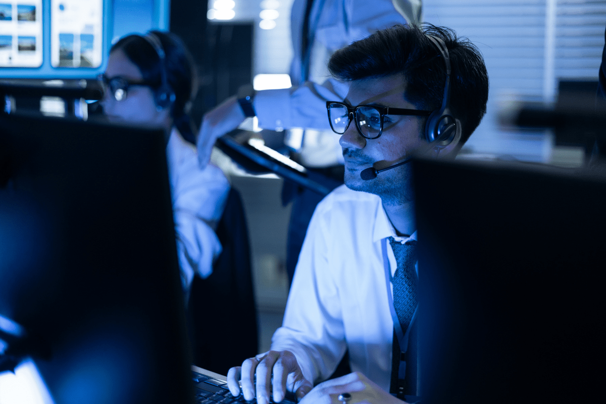 PCe Solutions Tampa IT cybersecurity support team wearing headsets monitoring screens in a 24/7 operations center providing round-the-clock managed IT helpdesk and threat detection for Tampa Bay businesses