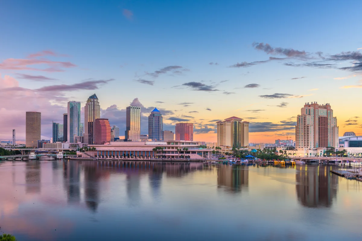 Tampa Florida downtown skyline at sunset reflecting over Hillsborough Bay representing the thriving business community served by PCe Solutions local managed IT services and cybersecurity support across Tampa Bay