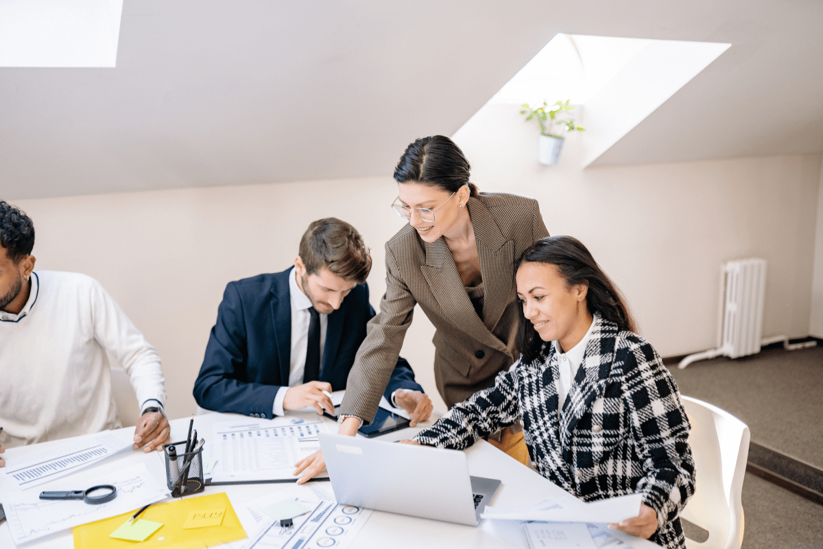 Tampa business team collaborating on AI workflow automation tools in a modern conference room representing PCe Solutions Managed Intelligence AI services for Tampa Bay organizations across healthcare financial services and aerospace sectors