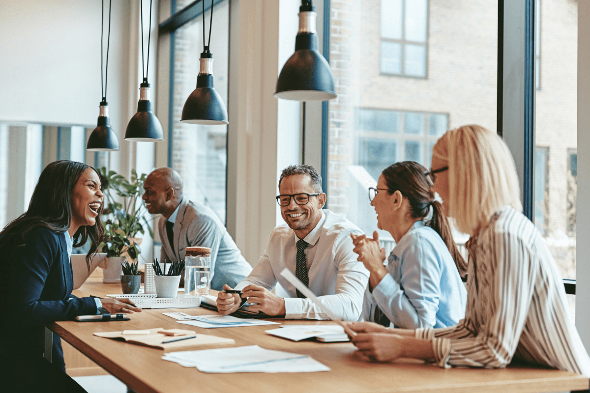 Tampa business leadership team reviewing a technology roadmap and strategic IT planning documents in a modern office boardroom representing PCe Solutions IT Consulting and Strategy services for growing Tampa Bay businesses